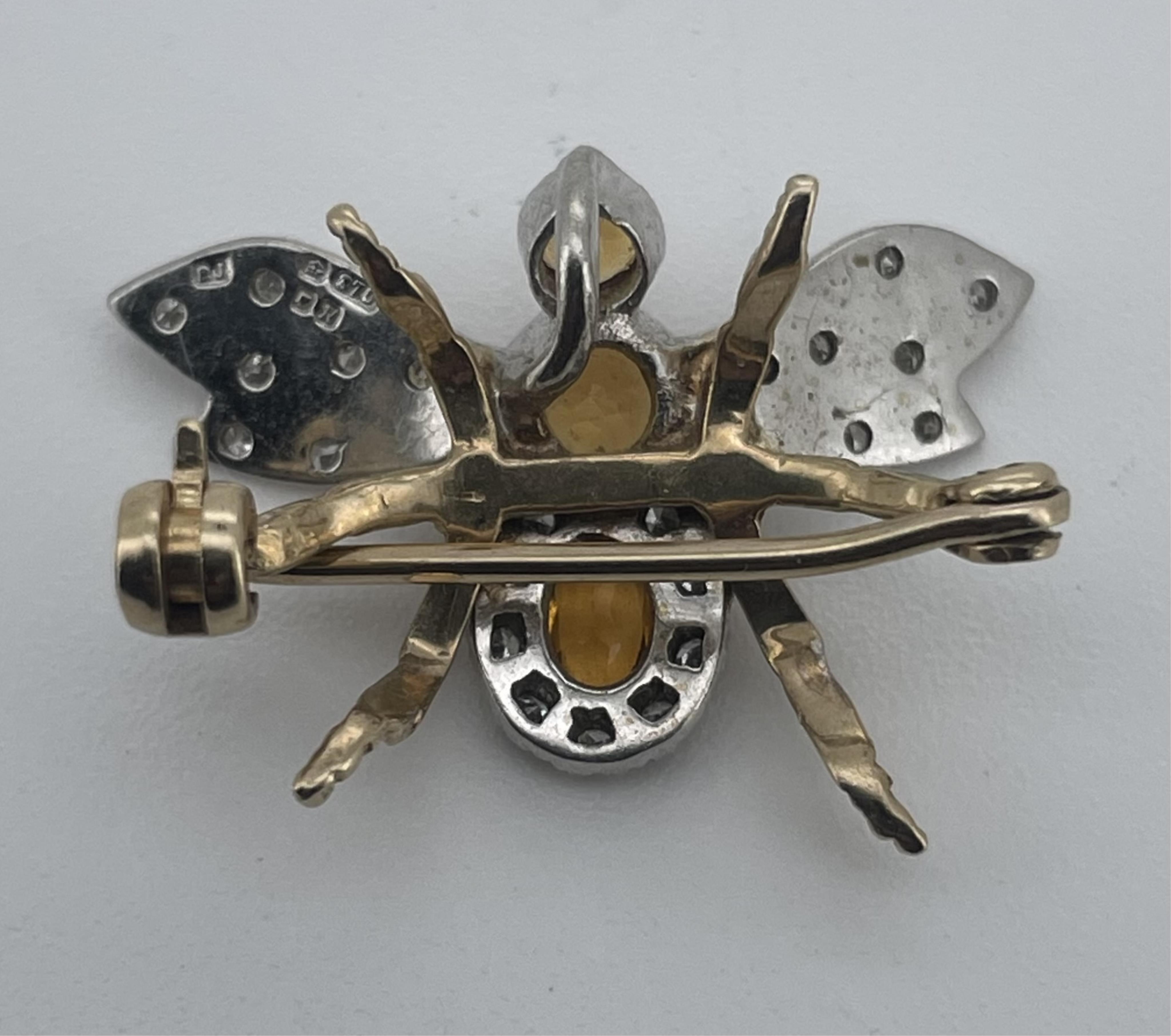 A citrine and diamond brooch, circa 1987, designed as a bee, set with circular-cut and oval yellow citrines and brilliant-cut diamonds, mounted in bicoloured 9ct gold, wingspan approximately 2.4cm, British hallmarks for